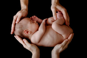 Picture of hands gently holding a baby